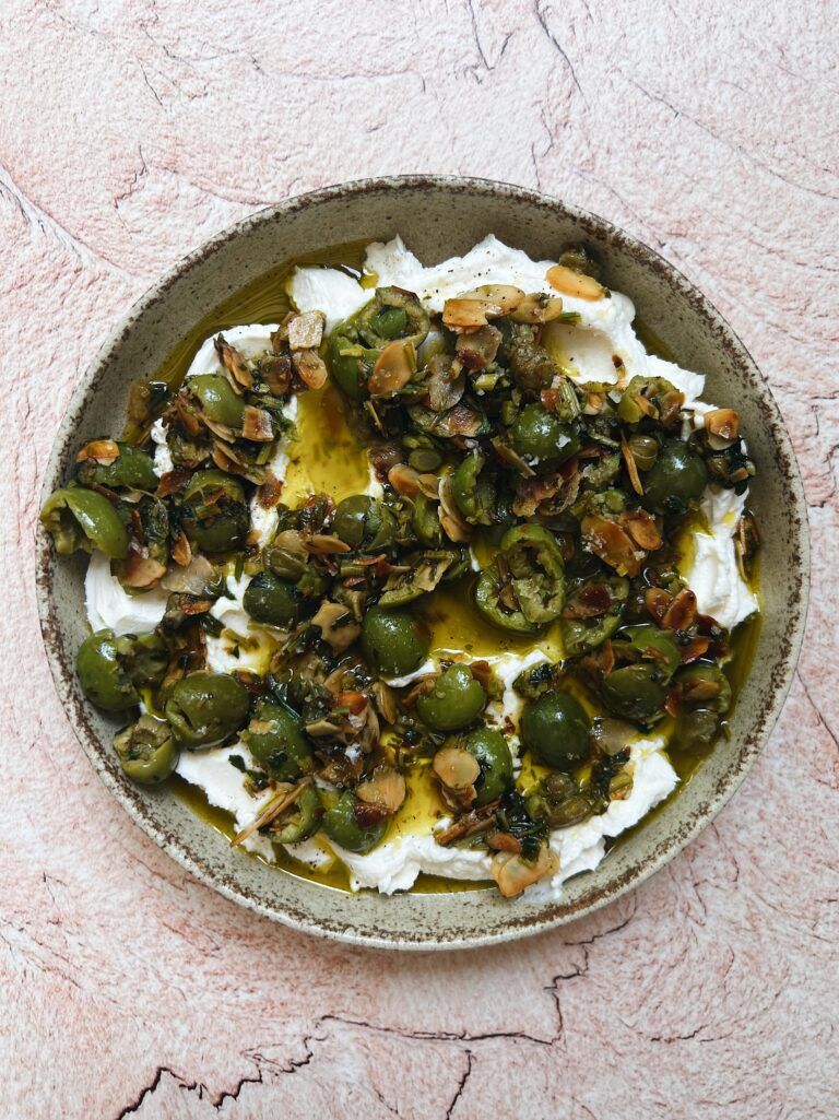 Whipped ricotta with crushed olives, lemon and pinenuts
